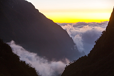 Mist moving up the Modi Khola valley in the Annapurna Sanctuary, in the Nepal Himalayas, Nepal, Asia