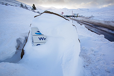 Snow drifts covering a welcome sign at the Cairngorm Ski Centre near Aviemore, Scotland, United Kingdom, Europe