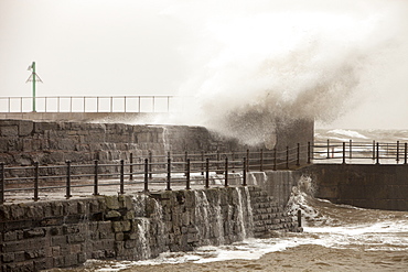 Gale force winds and crashing waves battering the coastal defences in Harrington, Workington, Cumbria, England, United Kingdom, Europe