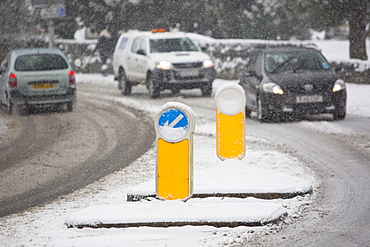 Cars driving through heavy snow in Ambleside, Lake District, Cumbria, England, United Kingdom, Europe