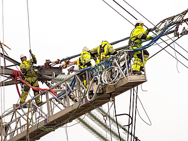 Technicians working to replace old insulators on a pylon in Barrow on Soar, Leicestershire, England, United Kingdom, Europe