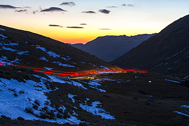 Car lights over Wrynose Pass at sunset, Lake District, Cumbria, England, United Kingdom, Europe