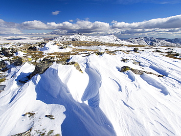 Drifting snowpack on Scafell Pike, looking towards Bow Fell and Crinkle Crags, Lake District, Cumbria, England, United Kingdom, Europe