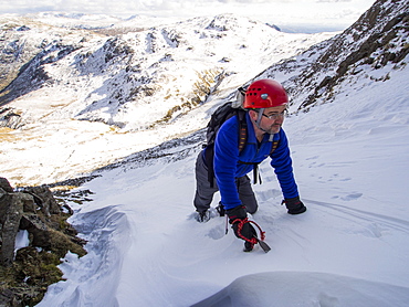 A climber in Custs Gully on Great End, a grade one winter route, Lake District, Cumbria, England, United Kingdom, Europe