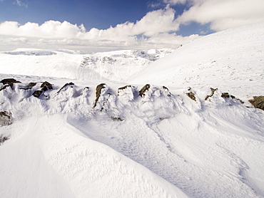 A wall and wind sculpted snow on High Street in unseasonally cold weather in late March 2013, Lake District, Cumbria, England, United Kingdom, Europe