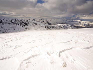 Looking towards Helvellyn fom Gray Crag during unseasonally cold weather in late March 2013, with drifting snow, Lake District National Park, Cumbria, England, United Kingdom, Europe