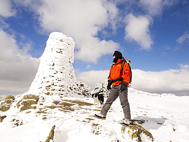 Thornthwaite Beacon plastered in hoar frost in unseasonally cold weather in late March 2013, with a hardy fell walker, Lake District, Cumbria, England, United Kingdom, Europe