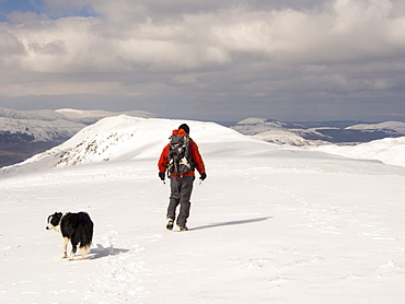 A walker on Gray Crag looking north in unseasonally cold weather in late March 2013, Lake District, Cumbria, England, United Kingdom, Europe