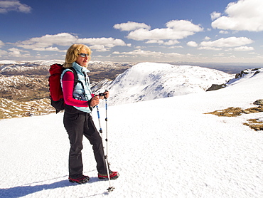 A woman fell walker on Great Carrs looking towards Wetherlam in the Lake District, Cumbria, England, United Kingdom, Europe