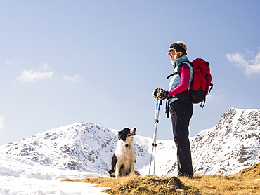 A woman fell walker on Wet Side Edge looking towards Great Carrs in the Lake District, Cumbria, England, United Kingdom, Europe