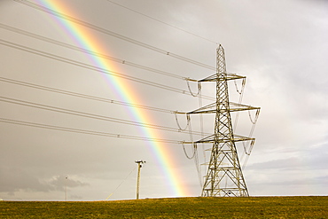 A rainbow over electricity pylons leaving Wylfa nuclear power station on Anglesey, Wales, United Kingdom, Europe