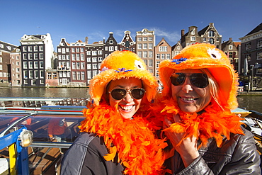 Dutch women celebrating Queens Day in Amsterdam, Netherlands, Europe