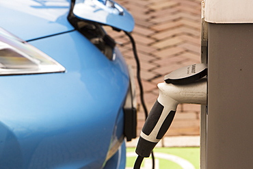 A Nissan Leaf charging at a charging station for electric cars in Amsterdam, Netherlands, Europe