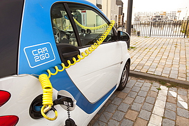 A Smart car at a charging station for electric cars in Ijburg, Amsterdam, Netherlands, Europe