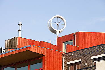 A small scale wind turbine on a house in Ijburg, Amsterdam, Holland, Europe