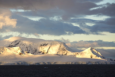 Light on mountainous scenery in Graham Land in Wilhelmina Bay on the Antarctic Peninsular, which is one of the fastest warming places on the planet.