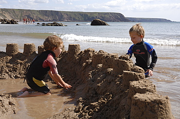 Building sandcastle, Marloes Sands, Pembrokeshire, Wales, UK