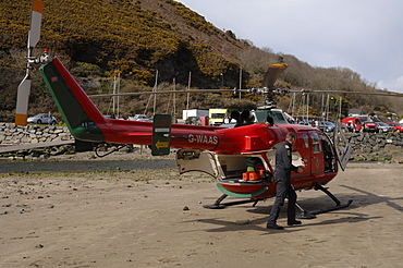 Wales Air Ambulance helicopter and crew rescuing a casualty at Solva harbour, Solva, Pembrokeshire, Wales, UK, Europe