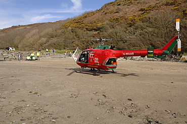 Wales Air Ambulance helicopter and crew rescuing a casualty at Solva harbour, Solva, Pembrokeshire, Wales, UK, Europe