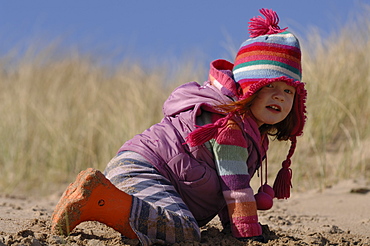 Young girl in sand dunes, Broad Haven South, Stackpole, Pembrokeshire, Wales, UK, Europe