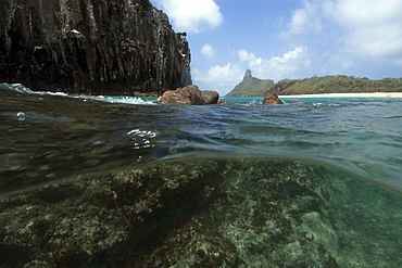 Underwater rocks and Pico hill, Cacimba do Padre Beach, Fernando de Noronha, UNESCO World Heritage Site, Brazil, South America