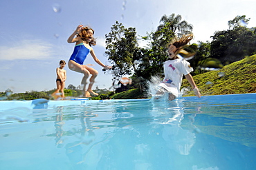 Kids jumping into the family pool, Guararema, Sao Paulo, Brazil, South America