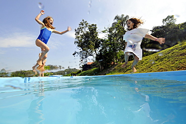 Kids jumping into the family pool, Guararema, Sao Paulo, Brazil, South America