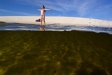 Tourist enjoys the lake in the Lencois Maranhenses National Park, Santo Amaro, Maranhao, Brazil, South America