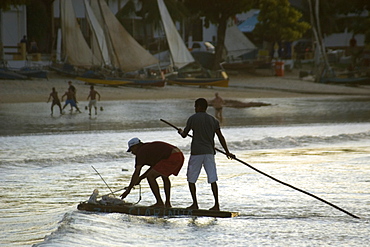 Fishermen in a traditional fishing raft at dusk, Natal, Rio Grande do Norte, Brazil, South America