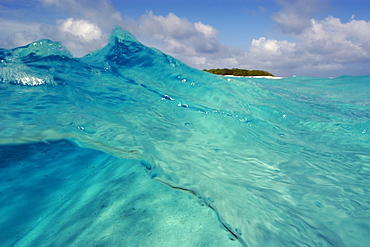 Split image of wave showing sandy bottom and island, Rongelap, Marshall Islands, Micronesia, Pacific