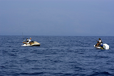 Local fishermen use jet ski to fish for skipjack tuna or aku, Big Island, Hawaii, United States of America, Pacific