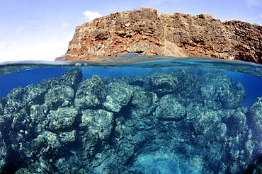 Split image of Lanai and underwater rocks and reef, Lanai, Hawaii, United States of America, Pacific