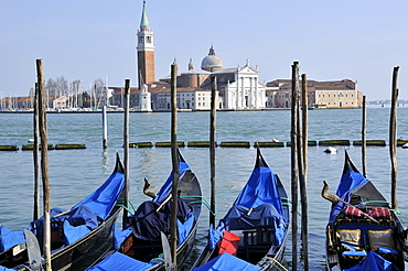 Four gondolas parked in Venetian lagoon, with San Giorgio Maggiore Island in the background, Venice, UNESCO World Heritage Site, Veneto, Italy, Europe