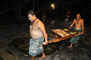 Slow cooked pork taken from imu is carried back to serving area, Kona Village Resort Luau, Kailua-Kona, Big Island, Hawaii, United States of America, Pacific