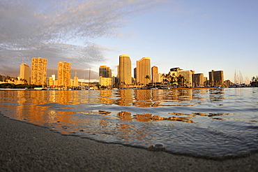 Buildings and hotels at Waikiki waterfront at dusk, Ala Moana Beach Park, Waikiki, Oahu, Hawaii, United States of America, Pacific