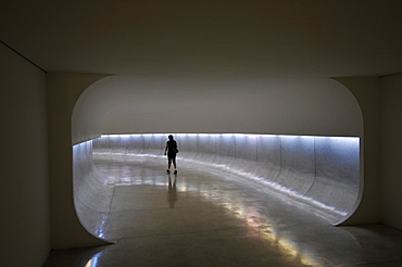 A person walks down the tunnel inside Oscar Niemeyer Museum, Curitiba, Paranu, Brazil, South America