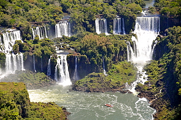 Aerial view of Iguassu Falls, UNESCO World Heritage Site, and rafting safari on Iguassu River, border between Brazil and Argentina, South America