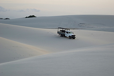 Truck trespassing sand dunes of Lencois Maranhenses National Park, Santo Amaro, Maranhao, Brazil, South America