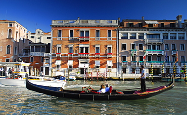 Tourists in a Gondala on a canal in Venice, Italy