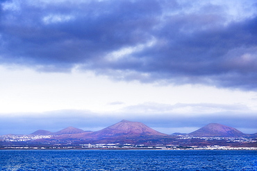 Spain, EspaÃ±a, Canary Islands, Canarias, Lanzarote, Arrecife, Volcanic Landscape with buildings.. Arrecife, Arrceife Harbour, Lanzarote. Canary Islands,  Spain, EspaÃ±a