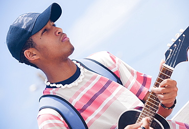 04/04/2009. Live music by the beach in Bahia dos Gatos. Man playing acoustic guitar. Mindelo, Sao Vicente Island Of the Cape Verde Islands. Mindelo, Sao Vicente Island. Cape Verde Islands