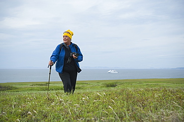 Tourist  Female hiker walking, exploration on Bering Islands (Bering Sea) Russia, Asia