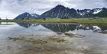 Abandoned Herring fishing settlement, tsunami damage, building debris, Landscape view of snow caped mountains, Yuzhnaya Glybokaya Bay (Bering Sea) Russia, Asia