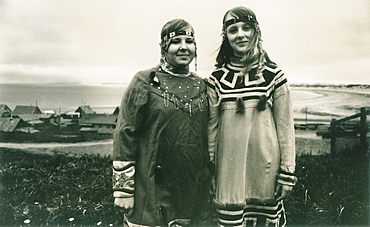 Two local girls, traditional inuit dress, town center of Nikolskoye Village, Bearing Sea, Russia, Asia