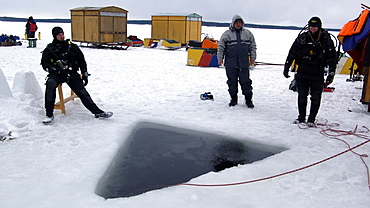 Ice diver under the ice in Northern Russia in the White Sea. Russia