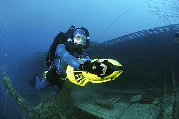 Mixed gas rebreather diver using scooter for mobility.  Red Sea.