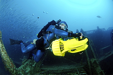 Mixed gas rebreather diver using scooter for mobility.  Red Sea.