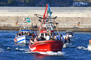 The Virgen del Carmen, wrapped in protective plastic, being carried out to sea from Tarifa, accompanied by a flotilla of boats, Tarifa, Cadiz, Andalusia, Spain, Europe