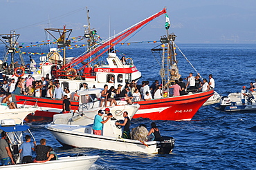 Chaotic scene at sea, as the Virgen del Carmen from Tarifa is taken on an annual ritual voyage with small boats in attendance, Cadiz, Andalusia, Spain, Europe