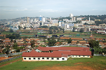 A view of the Kampala skyline with it's rail track and industrial buildings in the foreground.  This is Kampala's Central Business District. Kampala, Uganda, East Africa